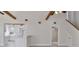 Open concept living space features vaulted ceilings, wood beams, and seamless flow to updated kitchen at 2728 58Th S St, Gulfport, FL 33707