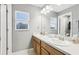 Well-lit bathroom with dual sinks, spacious counter, and a window providing natural light, creating an open space at 3046 Donington Castle Ln, Land O Lakes, FL 34638