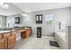 Primary bathroom showcasing double sinks, granite countertops, tile flooring, and a separate soaking tub at 3046 Donington Castle Ln, Land O Lakes, FL 34638