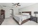 Large bedroom featuring carpeted floors, a comfortable bed, an entryway and a ceiling fan at 3046 Donington Castle Ln, Land O Lakes, FL 34638
