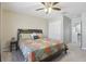 Comfortable bedroom with ceiling fan, side table, and closet for ample storage, offering a relaxing retreat at 3046 Donington Castle Ln, Land O Lakes, FL 34638