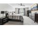 Cozy bedroom featuring a comfortable bed, a window, carpeted floors, and dark wood furniture at 3046 Donington Castle Ln, Land O Lakes, FL 34638