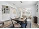 Spacious dining room with seating for six, modern lighting fixtures, and an open floor plan at 3046 Donington Castle Ln, Land O Lakes, FL 34638