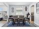 Bright dining room with seating for six, modern pendant lighting, and view into adjacent rooms at 3046 Donington Castle Ln, Land O Lakes, FL 34638