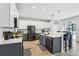Modern kitchen featuring stainless steel appliances, dual-toned cabinets, and a spacious island with seating at 3046 Donington Castle Ln, Land O Lakes, FL 34638