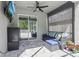 Covered patio with comfortable seating, ceiling fan, and a view of the screened-in pool area, ideal for relaxation at 3046 Donington Castle Ln, Land O Lakes, FL 34638
