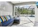 Inviting covered lanai featuring comfortable seating, an outdoor kitchen, and a view of the sparkling pool at 3046 Donington Castle Ln, Land O Lakes, FL 34638