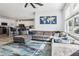 Open-concept living room flowing into kitchen, with a large sectional sofa and bright natural light at 3046 Donington Castle Ln, Land O Lakes, FL 34638