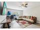 Comfortable living room with a sectional sofa, work space, natural lighting, and wood-look floors at 3046 Donington Castle Ln, Land O Lakes, FL 34638