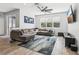 Comfortable living room with a large sectional sofa, ample natural light, and a ceiling fan at 3046 Donington Castle Ln, Land O Lakes, FL 34638
