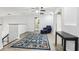 Cozy loft area with a comfortable chair, a colorful rug, and modern decor, creating a versatile living space at 3046 Donington Castle Ln, Land O Lakes, FL 34638