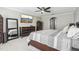 Spacious bedroom with a large bed, a ceiling fan, and a wall-mounted TV for a relaxing atmosphere at 3046 Donington Castle Ln, Land O Lakes, FL 34638