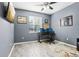 Spacious office with wood floors, three computer screens, and a window with views of the outside at 3046 Donington Castle Ln, Land O Lakes, FL 34638