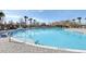 Inviting pool with a clear blue water, surrounded by palm trees and comfortable lounge chairs at 3046 Donington Castle Ln, Land O Lakes, FL 34638
