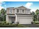 Charming two-story home featuring a two-car garage, landscaped yard, and a welcoming front entrance at 31350 Pendleton Landing Cir, Wesley Chapel, FL 33545