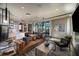 Open-concept living area featuring a cozy leather sofa, modern decor, and ample natural light at 31350 Pendleton Landing Cir, Wesley Chapel, FL 33545