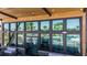 Stylish pool view from the clubhouse featuring outdoor seating and a covered patio at 31350 Pendleton Landing Cir, Wesley Chapel, FL 33545