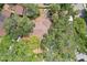 Aerial view of a home with a brown roof surrounded by mature trees and lush greenery at 3603 E Sterling Cir, Tampa, FL 33629