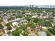 This home features an aerial view of a suburban neighborhood with lush greenery and stunning downtown skyline views in the distance at 3603 E Sterling Cir, Tampa, FL 33629