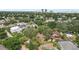 This is a serene aerial view of a neighborhood featuring lush greenery, established homes, and city views at 3603 E Sterling Cir, Tampa, FL 33629