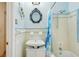 Full bathroom featuring blue and white tile, a shower-tub combo, and an ornate mirror at 3603 E Sterling Cir, Tampa, FL 33629