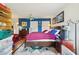 Bedroom features hardwood floors, blue accent wall, and lots of natural light at 3603 E Sterling Cir, Tampa, FL 33629