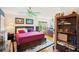 Bright bedroom featuring hardwood floors, ceiling fan, and views of the yard at 3603 E Sterling Cir, Tampa, FL 33629