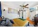 Bedroom with a ceiling fan, light-colored walls, hardwood floors and view into the hallway at 3603 E Sterling Cir, Tampa, FL 33629