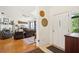 Welcoming entryway with view into living room with fireplace and hardwood floors at 3603 E Sterling Cir, Tampa, FL 33629