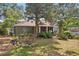 Home exterior with mature trees and a green lawn at 3603 E Sterling Cir, Tampa, FL 33629