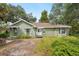 Quaint home with a green exterior, complemented by well-maintained landscaping at 3603 E Sterling Cir, Tampa, FL 33629