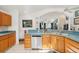 Close-up of the kitchen sink and countertop with stainless steel appliances and wood cabinets at 3603 E Sterling Cir, Tampa, FL 33629