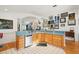 Kitchen featuring wooden cabinets, a stainless steel dishwasher, white tile floors, and unique decorations at 3603 E Sterling Cir, Tampa, FL 33629