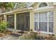 Covered porch features a swing, tile flooring, and large windows at 3603 E Sterling Cir, Tampa, FL 33629