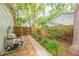 Landscaped backyard with a stone walkway, privacy fence, and lush greenery at 3714 Village Estates Pl, Tampa, FL 33618