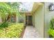 Front entrance with a well-lit walkway, lush landscaping, and a welcoming exterior at 3714 Village Estates Pl, Tampa, FL 33618