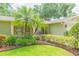 Exterior showcasing the lush front yard, stone accents, and well-maintained landscaping at 3714 Village Estates Pl, Tampa, FL 33618