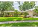 Charming home with lush lawn and well-manicured landscaping, with an attached two-car garage at 3714 Village Estates Pl, Tampa, FL 33618