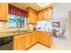 Bright kitchen with wooden cabinets, granite countertops, and an adjacent dining area at 3714 Village Estates Pl, Tampa, FL 33618