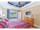 Bedroom with backyard access features a decorative ceiling, hardwood floors, and natural wood furniture at 3714 Village Estates Pl, Tampa, FL 33618