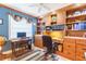 Home office features built-in shelving and drawers, hardwood floors, and a window for natural light at 3714 Village Estates Pl, Tampa, FL 33618