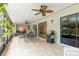 Outdoor patio featuring a grill, ceiling fans, and dining table at 3714 Village Estates Pl, Tampa, FL 33618