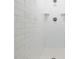 Close-up of white tiled shower with dual shower heads and tiled floor at 3714 Village Estates Pl, Tampa, FL 33618