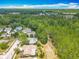 Aerial view showcasing the property's surroundings and neighborhood in a lush, green setting at 3932 Watson Dr, New Port Richey, FL 34655