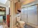 Bathroom with shower, cabinet storage, tiled floor and skylight overhead at 3932 Watson Dr, New Port Richey, FL 34655