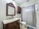 Traditional bathroom features a vanity with sink, a decorative mirror, and a shower at 3932 Watson Dr, New Port Richey, FL 34655