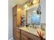 Bathroom with vanity, mirror, wooden cabinets, and essential items at 3932 Watson Dr, New Port Richey, FL 34655