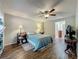 Comfortable bedroom featuring wood-look tile floors, ceiling fan, and neutral walls at 3932 Watson Dr, New Port Richey, FL 34655