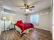 Comfortable bedroom showcasing wood floors, a ceiling fan, a window, and unique storage options at 3932 Watson Dr, New Port Richey, FL 34655