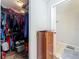 Spacious walk-in closet filled with clothes, next to a bathroom at 3932 Watson Dr, New Port Richey, FL 34655